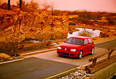 AUT 29 RK0676 06
2005 Volkswagen R32 Golf Red 3/4 Front View Crossing Bridge By Rocks Filtered