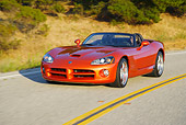 AUT 29 RK0857 01
2005 Dodge Viper SRT10 Convertible Copper Head Orange 3/4 Front View On Road In Motion