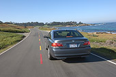 AUT 29 RK0916 01
2006 BMW 760i Gray Rear View On Road In Motion By Ocean