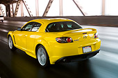 AUT 29 RK1159 01
2005 Mazda RX8 Yellow 3/4 Rear View On Road In Motion