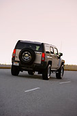 AUT 29 RK1369 01
2007 Hummer H3 Silver 3/4 Rear View On Road In Motion At Dusk
