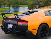 AUT 30 BK0019 01
2010 Lamborghini Murci�lago LP670-4 SV Orange 3/4 Rear Detail On Pavement By Pond