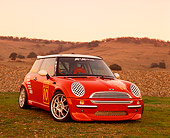 AUT 35 RK0128 02
2002 Mini Mania Mini Cooper Red 3/4 Front View On Grass Hills Background