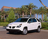 AUT 35 RK0217 02
2002 Pontiac Aztek White 3/4 Front View On Pavement By Palm Trees And Building