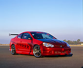 AUT 35 RK0332 04
2002 Acura RSX Type S Red With Graphics Modify By APC Low 3/4 Front View On Pavement Blue Sky