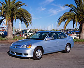 AUT 38 RK0063 02
2003 Honda Civic Hybrid Silver Blue Metallic 3/4 Front View On Pavement By Palm Trees At Harbor