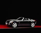 AUT 41 RK0065 06
2006 Pontiac, Solstice, Convertible Black 3/4 Side View On Red Floor Studio