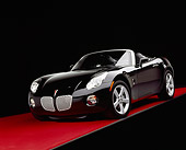 AUT 41 RK0067 06
2006 Pontiac, Solstice, Convertible Black 3/4 Front View On Red Floor Studio