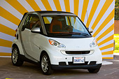 AUT 43 RK0106 01
2008 Smart Fortwo White 3/4 Front View On Pavement By Building