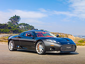 AUT 44 RK0103 01
2009 Spyker C8 Aileron Gray 3/4 Front View On Pavement By Field And Trees