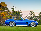AUT 45 BK0006 01
2010 Iconic AC Roadster Blue Profile View On Grass By Trees