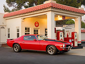 CAM 01 RK0122 01
1973 Chevrolet Camaro Z-28 Red And Black 3/4 Front View On Pavement By Gas Station