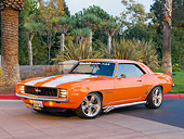 CAM 07 RK0090 01
1969 Chevrolet Camaro RS Orange White Stripe 3/4 Front View On Pavement By Trees