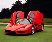 FRR 04 RK0320 02
2003 Ferrari Enzo Rosso Dino Red 3/4 Front View Doors Open On Grass By Trees