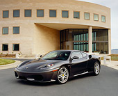 FRR 04 RK0384 04
2005 Ferrari F430 Grigio Silverstone 3/4 Front View On Pavement By Building
