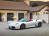FRR 08 RK0130 01
2009 Ferrari F430 16M Scuderia Spider Silver 3/4 Front View On Pavement By House