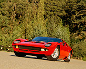 LAM 03 RK0011 08
1970 Lamborghini Miura S Red Low 3/4 Front Slanted View On Road By Trees