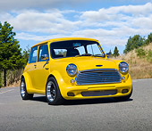AUT 22 BK0068 01
1961 Austin Mini Cooper Yellow 3/4 Front View On Pavement By Trees