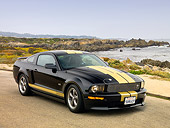 MST 03 RK0170 01
2006 Ford Shelby GT-H Black And Gold 3/4 Front View On Pavement By Water
