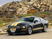 MST 03 RK0171 01
2006 Ford Shelby GT-H Black And Gold 3/4 Front View On Pavement By Rocks