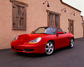 POR 04 RK0423 10
2000 Porsche Boxster S Convertible Red 3/4 Front View On Pavement By Building