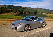 POR 04 RK0554 03
2004 Porsche X50 Turbo Silver 3/4 Front View On Road By Water And Trees