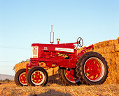 TRA 01 RK0125 03
1958 Farmall 350 High Clearance Red And White 3/4 Low Side View By Hay Stacks
