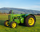TRA 01 RK0022 02
1935 John Deere Brass Tag Tractor 3/4 Side View On Grass
