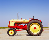 TRA 01 RK0081 02
1956 Cockshutt 35 Deluxe Red And Yellow Tractor Profile View On Dirt Blue Sky