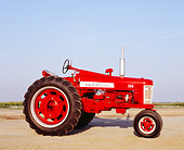 TRA 01 RK0100 02
1958 Farmall 350 Red Tractor Side View On Dirt Blue Sky