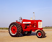 TRA 01 RK0104 04
1957 International Harvester Farmall 450 Red Tractor 3/4 Side View On Dirt Blue Sky