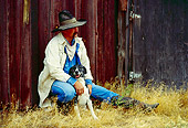 WRG 02 RK0071 02
Wrangler Leaning Against Barn Petting Dog