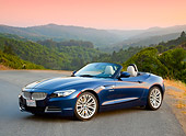 AUT 01 BK0002 01
2009 BMW Z4 Convertible Blue 3/4 Front View On Pavement By Hills