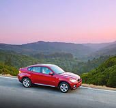 AUT 01 BK0004 01
2010 BMW X6 Sports Activity Vehicle Red 3/4 Front View On Pavement By Valley