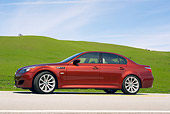 AUT 01 RK0247 01
2006 BMW M5 Burgundy 3/4 Side View On Pavement By Grass Hills