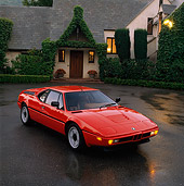 AUT 01 RK0003 03
1988 BMW M1 Red 3/4 Front View On Wet Pavement By House