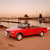 AUT 01 RK0011 02
1989 BMW Convertible Red Side 3/4 View On Dirt By Water At Dusk