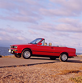 AUT 01 RK0015 01
1989 BMW Convertible Red Low 3/4 Front View On Pavement Cloudy Sky