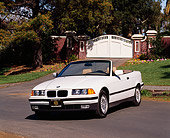 AUT 01 RK0028 07
1994 BMW 325 Convertible White 3/4 Front View On Pavement By Gate