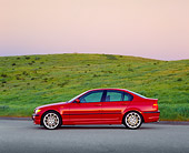 AUT 01 RK0181 06
2003 BMW 330i Sport Sedan Red Profile On Pavement By Grass Hill Filtered