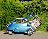 AUT 01 RK0204 01
1958 BMW Isetta 300 Light Blue Door Open Profile View On Pavement By Shrubs