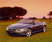 AUT 01 RK0211 02
2005 BMW 645Ci Convertible Blue 3/4 Front View On Grass By Trees Filtered