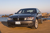 AUT 01 RK0233 01
2006 BMW 760i Gray Low 3/4 Front View On Sand By Ocean And Rocks