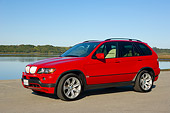 AUT 01 RK0244 01
2006 BMW X5 Red 3/4 Side View On Pavement By Water Blue Sky