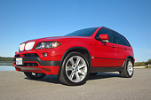 AUT 01 RK0245 01
2006 BMW X5 Red Low 3/4 Side View On Pavement By Water Blue Sky