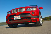AUT 01 RK0246 01
2006 BMW X5 Red Low 3/4 Front View On Pavement Blue Sky