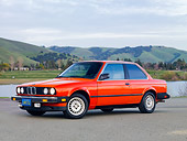 AUT 01 RK0331 01
1984 BMW 318i Red 3/4 Front View On Pavement By Hills
