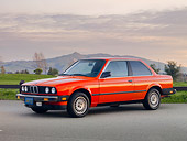 AUT 01 RK0334 01
1984 BMW 318i Red 3/4 Front View On Pavement By Hills