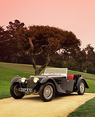 AUT 02 RK0045 12
1937 Bugatti Convertible Black 3/4 Front View On Sand By Grass And Tree Pebble Beach