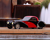 AUT 02 RK0018 04
1937 Bugatti Atalante 57SC Coupe Red And Black 3/4 Side View By Water Fountain